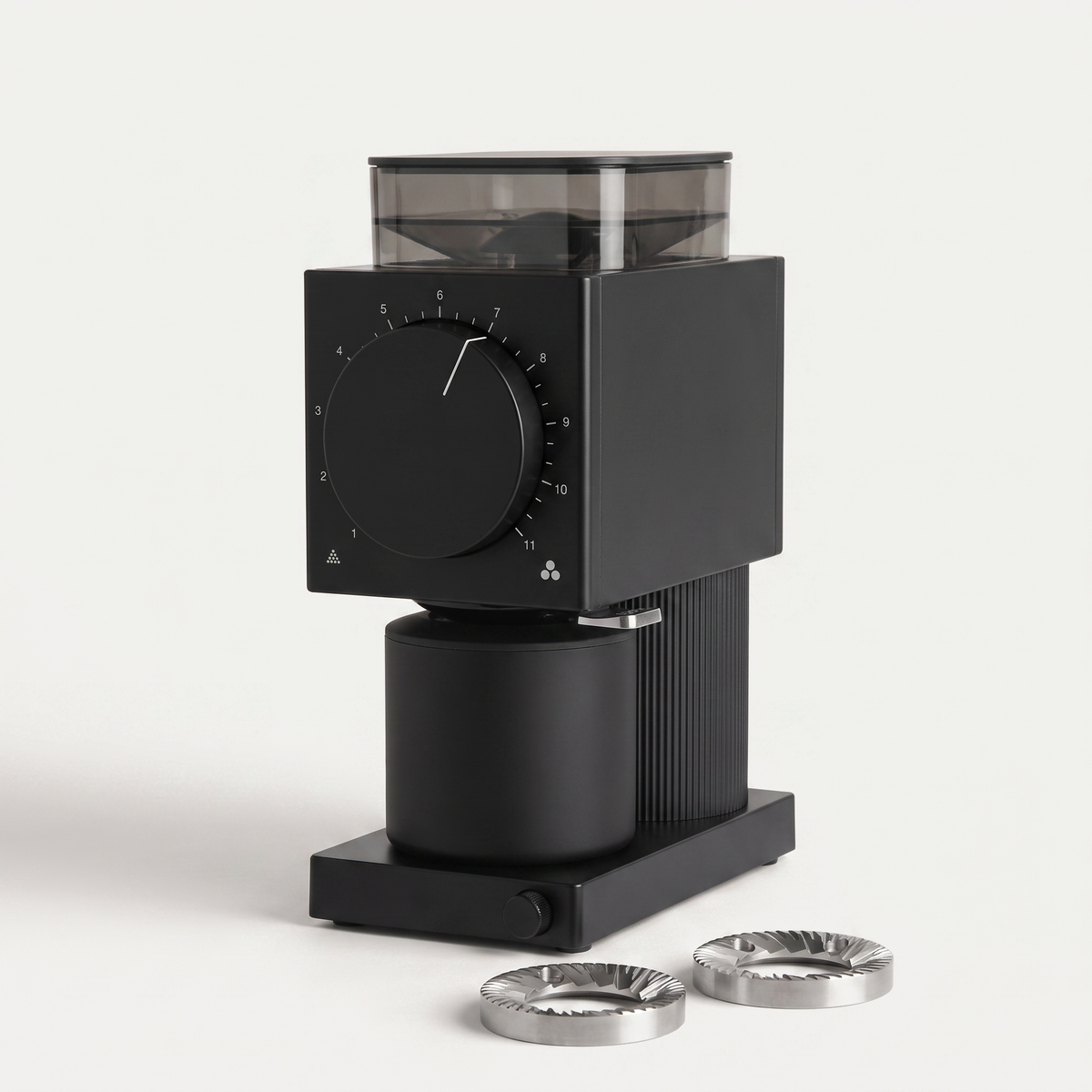 Electric burr coffee grinder seen from the front with its two stainless burr rings