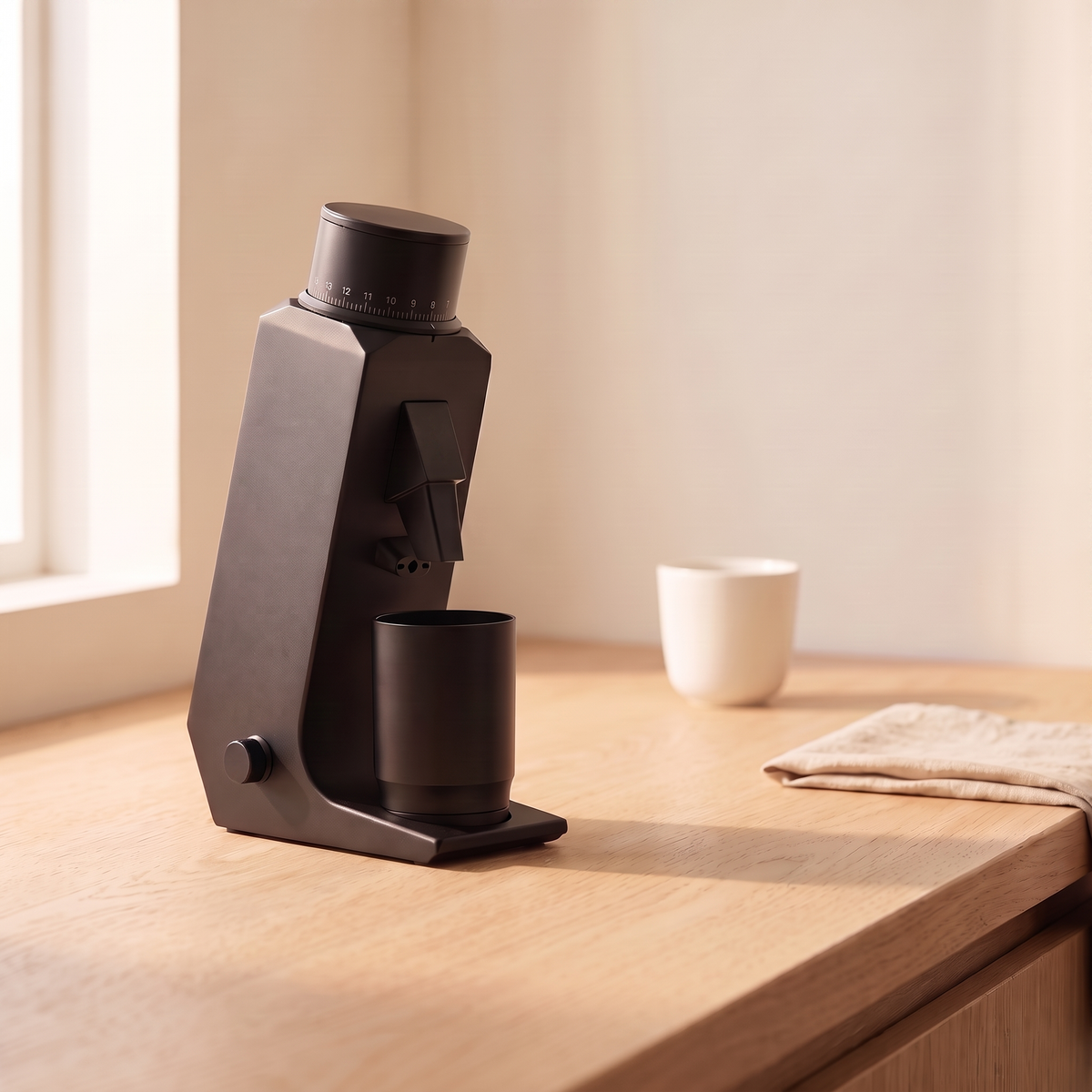 CAFOVO G255CV coffee grinder on a wooden counter beside a cup