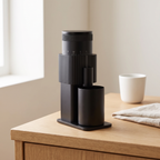 All black CF Wisdom portable burr coffee grinder on a kitchen counter