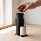 Hand lifting the wooden lid off the CF Wisdom portable coffee grinder