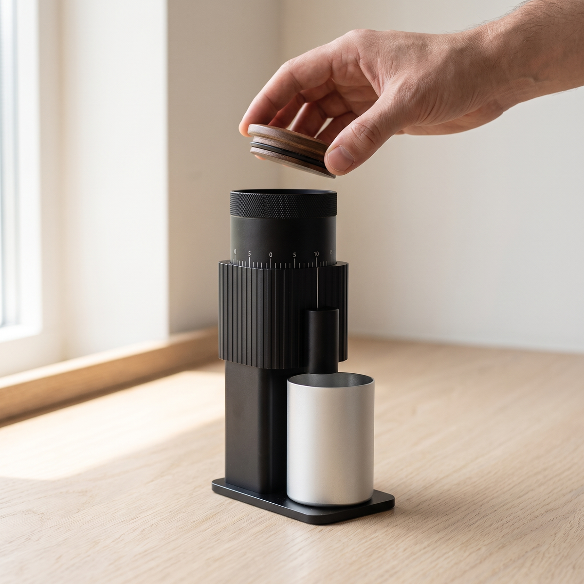 Hand lifting the wooden lid off the CF Wisdom portable coffee grinder