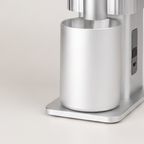 Close-up of the grounds cup and control panel of the silver CF Wisdom grinder