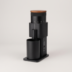Black CF Wisdom portable grinder with walnut lid, three-quarter view