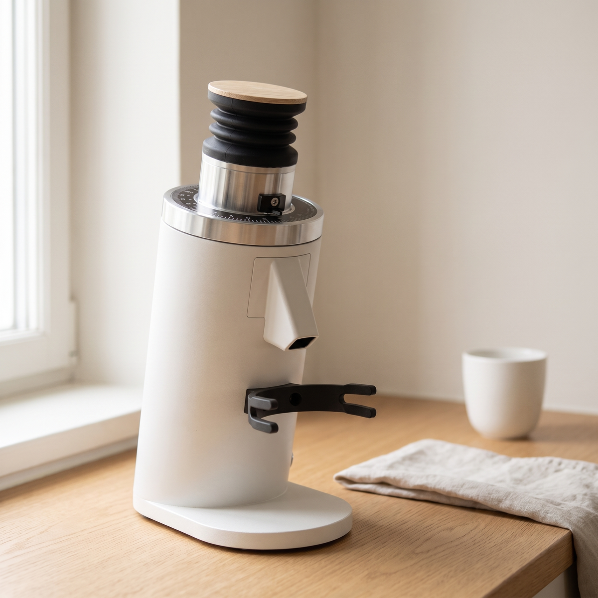 White DF54 flat burr espresso grinder on a light oak kitchen counter