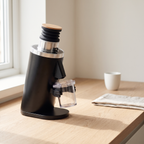 DF54 espresso grinder on an oak kitchen counter in morning light