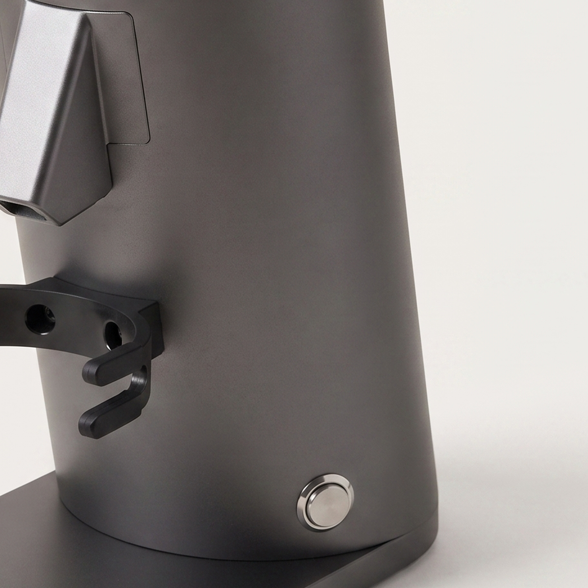Close-up of the chute and portafilter fork of the grey DF54 grinder