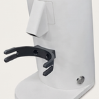 Close-up of the chute and portafilter fork of the white DF54 grinder