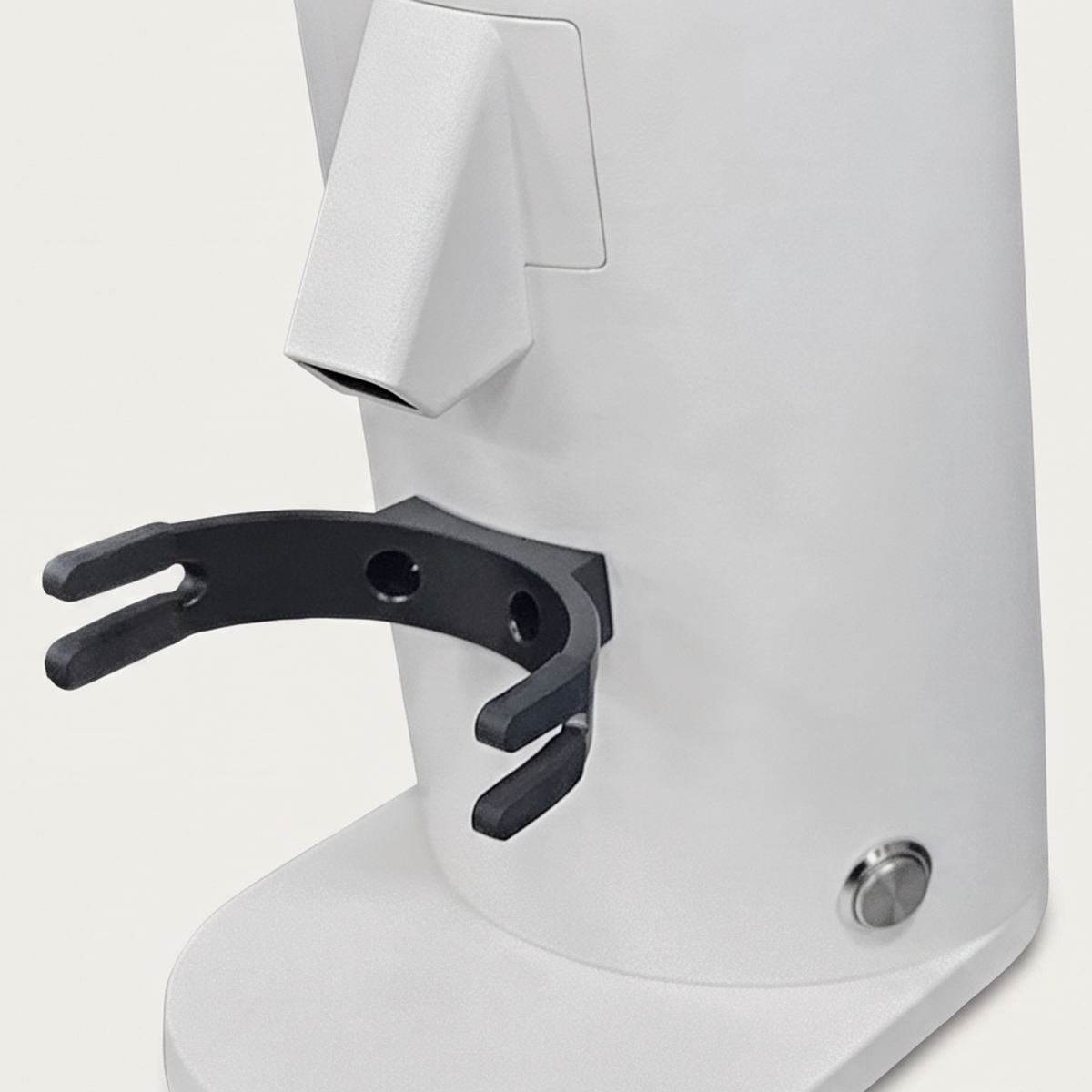 Close-up of the chute and portafilter fork of the white DF54 grinder