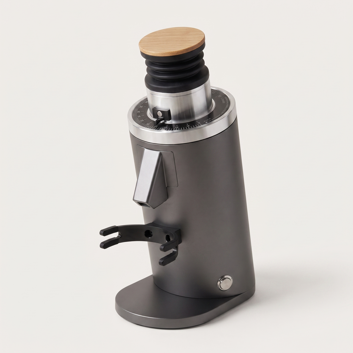 DF54 coffee grinder in grey, three-quarter view with the portafilter fork