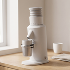 White GZZT GF64 flat burr coffee grinder on a light oak kitchen counter