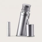 Single dose burr coffee grinder in brushed aluminium, shown with its dosing cup and the anti-static spray bottle