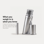 Single dose burr coffee grinder with sealed dosing cup and coated grind path