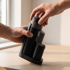 Hands turning the knurled top collar of the STARSEEKER Go50 coffee grinder