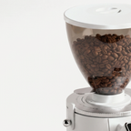 Close-up of the hopper filled with beans on the white SUBARASI IT-CG17 grinder