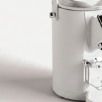 Close-up of the chute and portafilter fork of the white SUBARASI IT-CG17 grinder